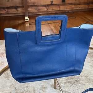 TMRW studios blue leather bag.